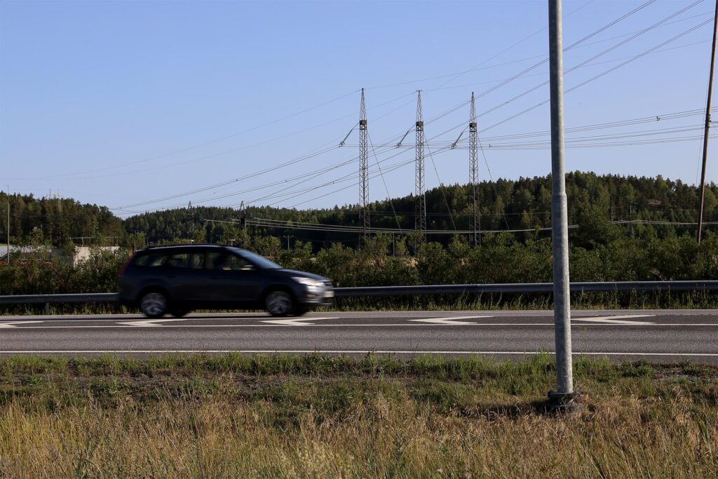 Auto ajaa asfaltoidulla tiellä
